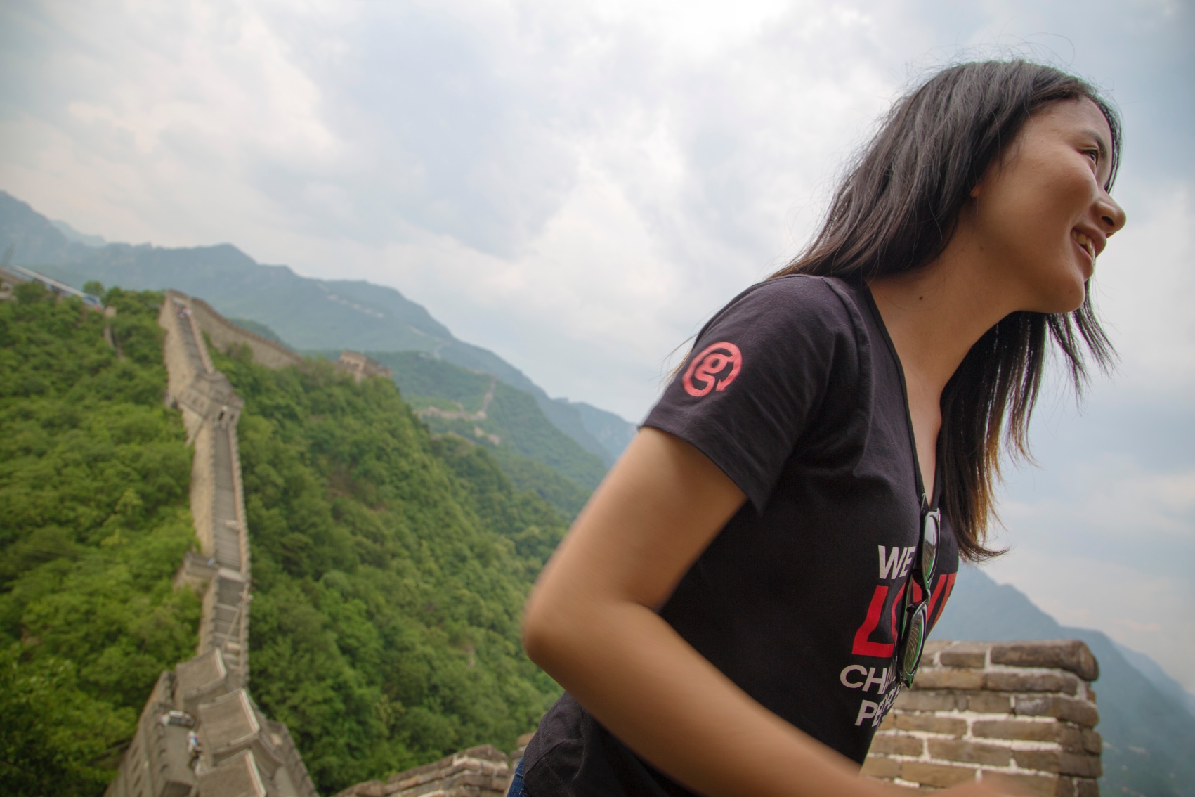 a female CEO looks out over the Great Wall of China
